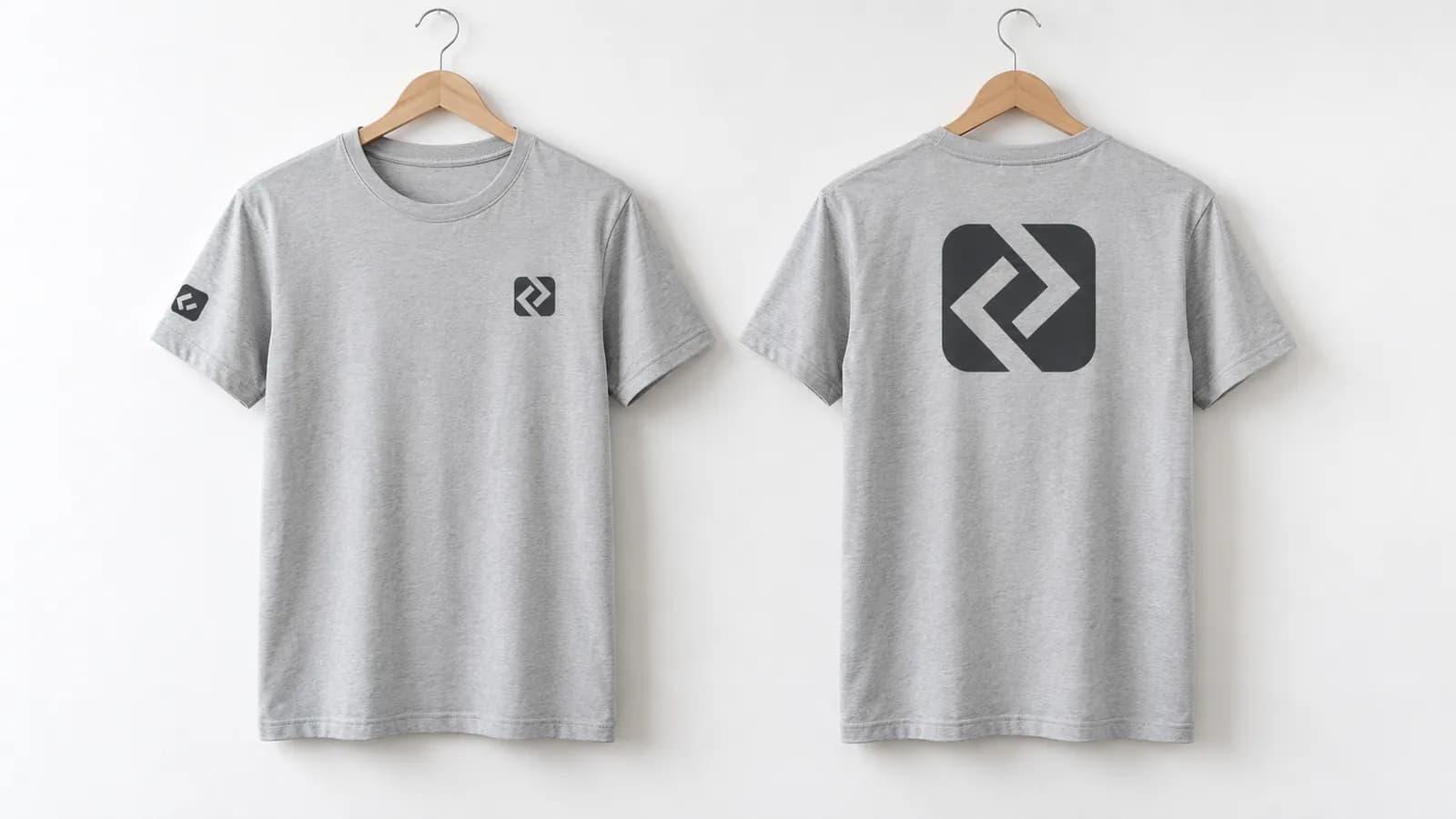 Grey T-shirts on hangers: front with a chest logo and sleeve mark, back with a large print